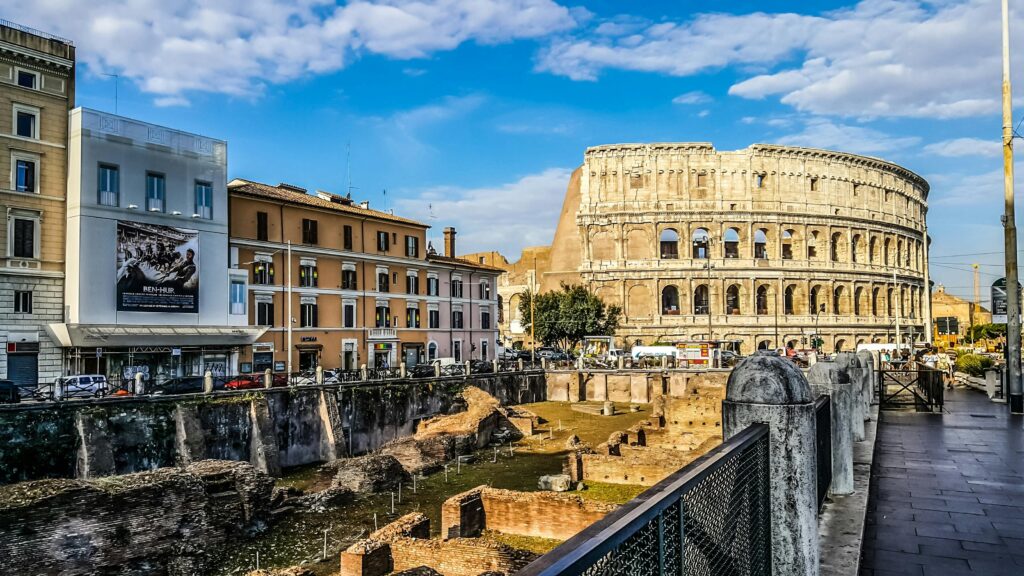 The ruins of Rome's Colosseum sit under a sunny sky